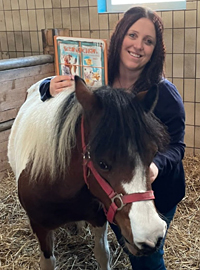 Foto von Katharina Hilberg mit Pferd und Buch